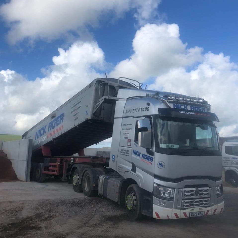 Renault T480 Truck Unloading A Renault T480 lorry from Nick Ager Haulage with its trailer tilted for unloading, set against a cloudy blue sky.