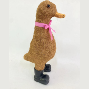 A decorative duck made of natural fibres, featuring a pink ribbon around its neck and wearing black rubber boots.