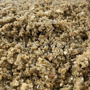 A close-up view of natural sand with a variety of textures and colours, showcasing grains of different sizes and materials.