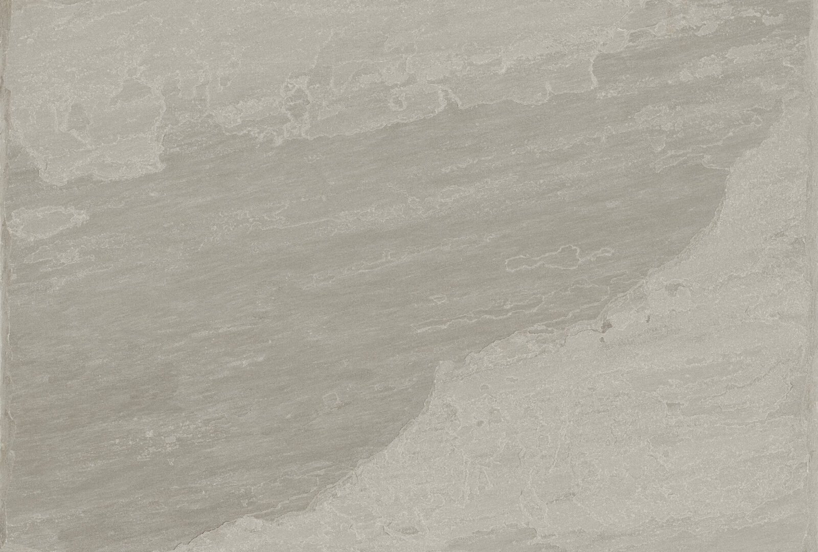 A close-up view of a textured grey stone surface with subtle variations in tone and shading.