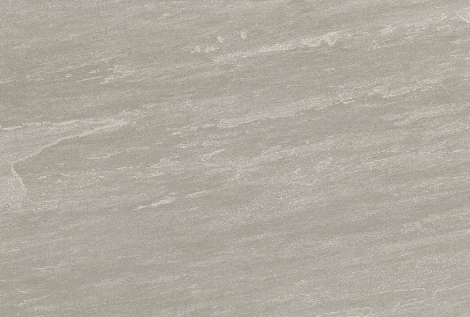 A close-up view of a textured grey surface with subtle lines and patterns, resembling natural stone.