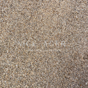 A detailed view of sand displaying a variety of small grains in shades of brown and beige.