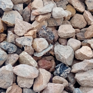 A close-up image showing a selection of small, multicoloured stones of various shapes and sizes, featuring earthy tones and textures.