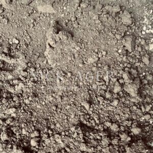 A close-up view of soil showing a mix of fine dirt and small pebbles, with a textured surface and various shades of brown.